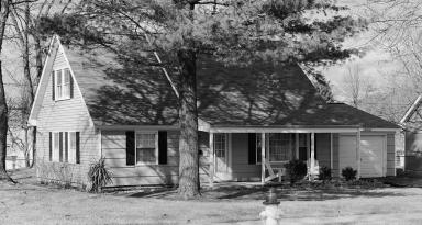 One of the original Levitt Belair homes, in the "S" section, after all the grass and trees grew in. This model is the Cape Cod, the most affordable option. (Source: Library of Congress)