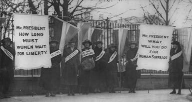 Women suffragists picketing in front of the White house on "College Day" in 1917. (Source: Wikipedia)