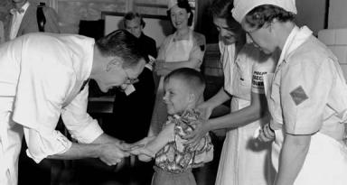 Dr. Richard Mulvaney administers the trial Polio vaccine to six-year-old Randall Kerr (Source: March of Dimes)